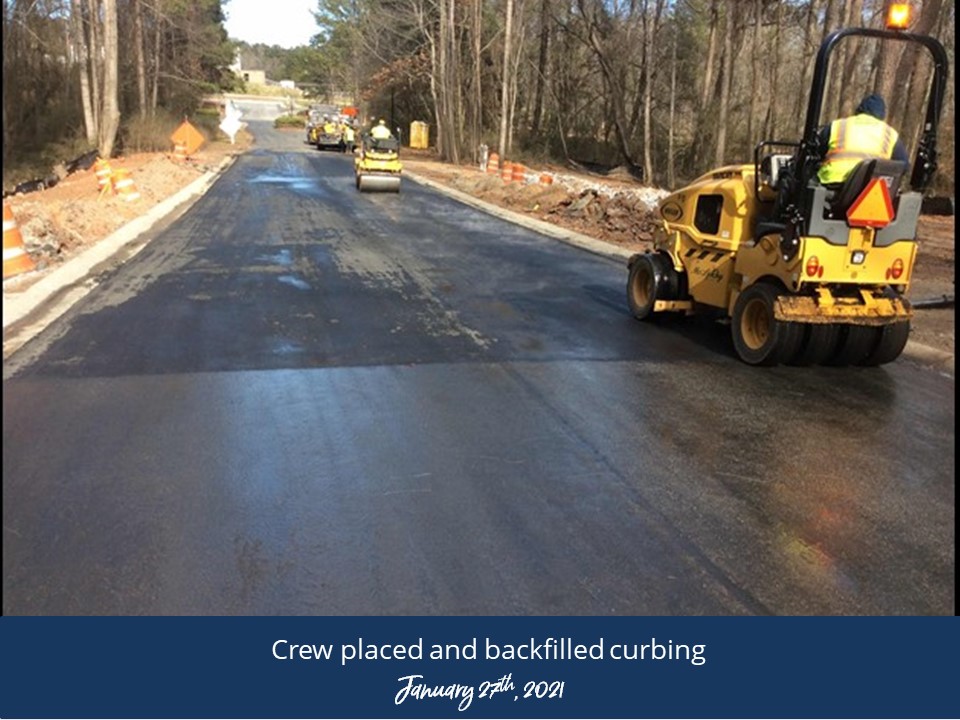 A road crew is actively repairing a section of the road